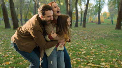 Happy family hugging together love adopted custody little child kid daughter girl parents hug...