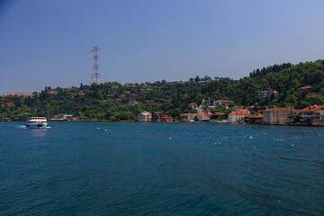 Fototapeta premium Blue seascape overlooking the coast. View of the Bosphorus in Istanbul city on sunny summer day, in a public place.