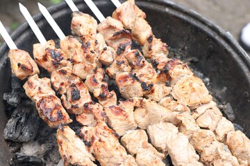 Cooking delicious kebab on metal brazier outdoors, above view