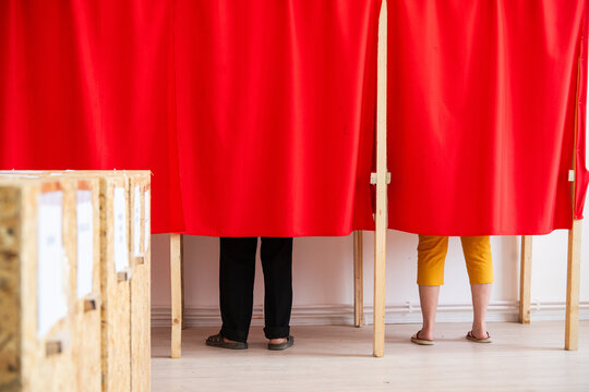 People vote in polling booths during elections.