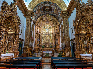 The intricate golden interior of the Carmelite church Igreja do Carmo in the old town of Faro in...