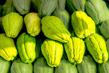 Fresh chayote fruit on the vegetable stand