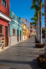 Fototapeta premium Colorful houses with palm trees in the streets of 