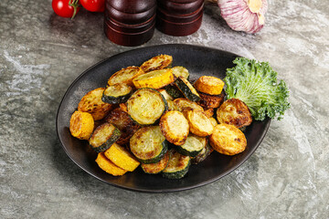 Roasted young zucchini in the plate