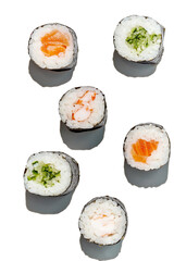 Various maki rolls with shrimp, salmon, cucumber on a white background with hard shadows