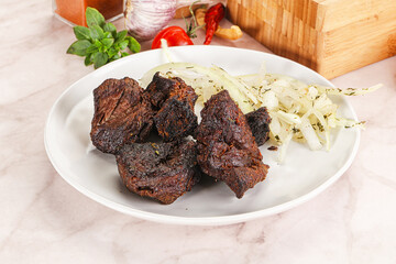 Grilled beef barbecue served onion