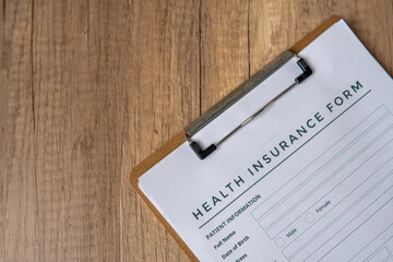 A close-up image of health insurance form on a clipboard. Medical and insurance concept. Copy space for text.