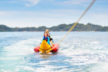 Banana boat ride. Kids on the beach.