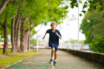 Kids run in summer park. Active child running.