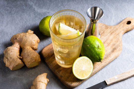 Fresh ginger ale drink on gray background