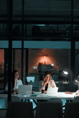 Employee, women and laptop in office at night with documents for deadline or overtime as...