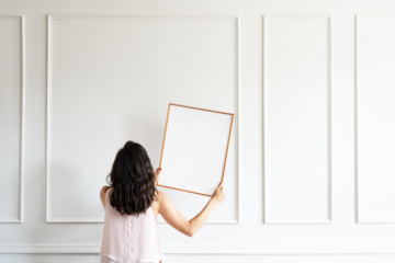 Picture frame png mockup, woman decorating wall, transparent design