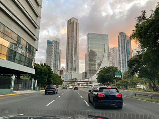 Driving on a busy road through modern part of Panama city with high skyscrapers