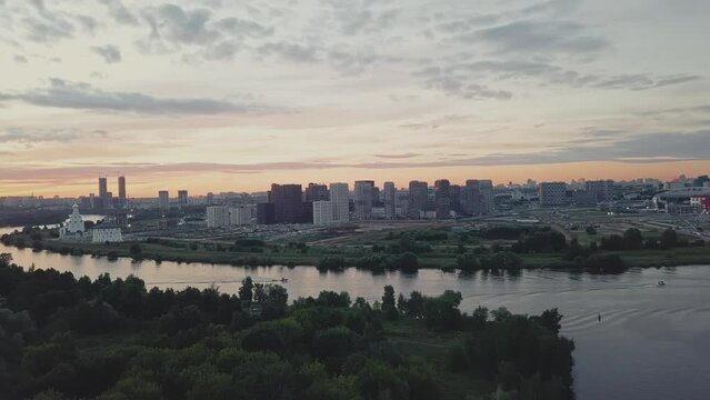 A green district of city with parks, river and high-rise residential buildings.