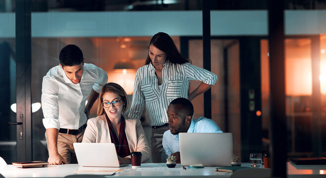 Collaboration, team diversity and office at night for deadline, strategy and explanation with laptop. Female leader, group and workshop for learning, growth and development in workplace in evening
