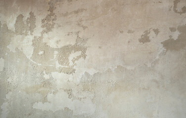 Gray concrete rough wall with peeling white paint and cracks texture background