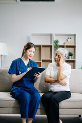 Asian caregiver doctor examine older patient use blood pressure gauge. woman therapist nurse at nursing home taking care of senior elderly