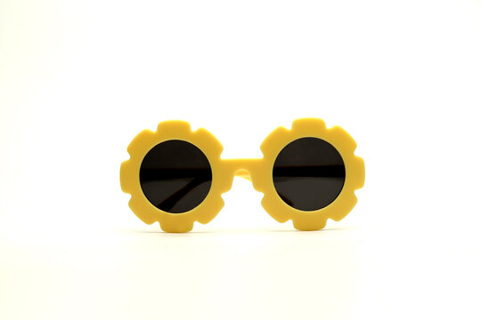 yellow flower-shaped sunglasses on a white background