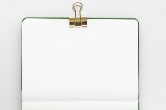 Blank notebook page with a bulldog clip design element