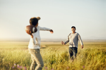 Father, son or American football in nature for bonding, skills practice with dad in outdoor. Male...