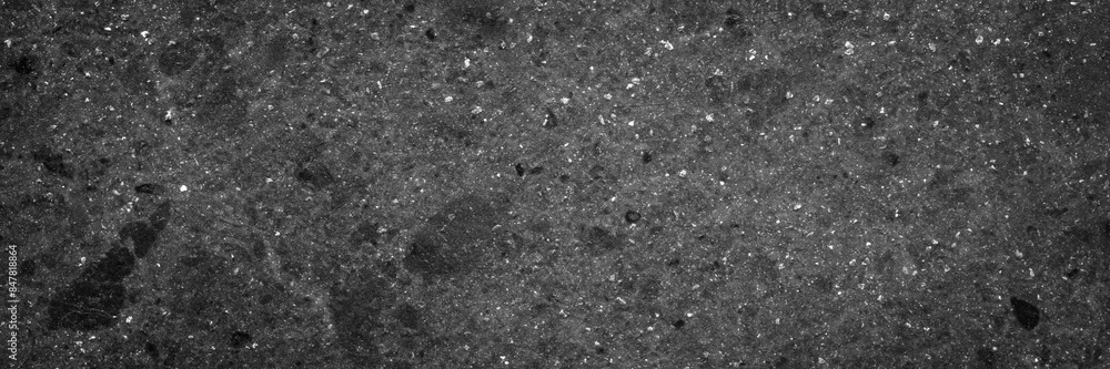 Poster a black and white photo of a rocky surface with a lot of dirt and debris. the photo has a moody and 