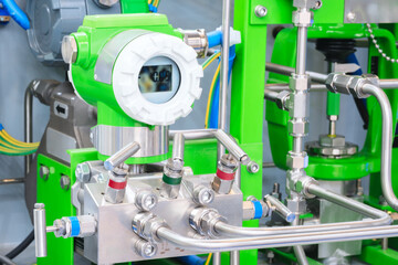 A green industrial machine with a white screen that says 