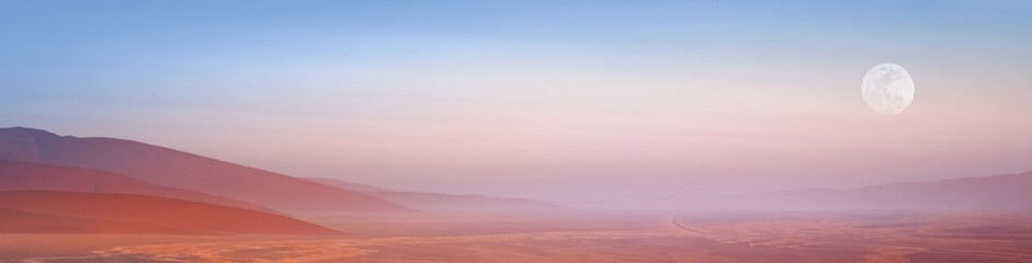 Namib desert with moon and red sand dunes in morning haze, Namibia.