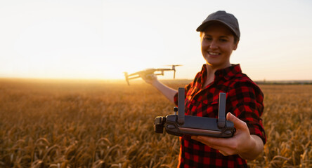 Woman farmer with drone on a wheat field. Smart farming and precision agriculture