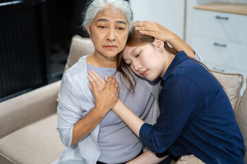 Grandmother embraces granddaughter with love and care.