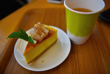 A delicious afternoon tea with a slice of cake and a steaming cup of tea