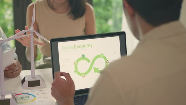 A business team discusses the principles of a circular economy and sustainable practices during a strategy session.