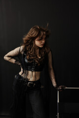 young punk woman stands out in her black sheer top and bold jewelry choices, radiating a mix of strength and vulnerability. Each photo captures her raw beauty and unconventional charm