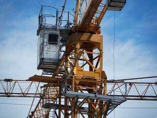 Yellow construction tower cranes against blue sky. Construction site. Architectural concept. Industry. Ust-Kamenogorsk (kazakhstan)
