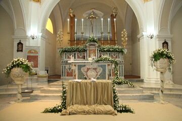 Romantic wedding ceremony in a beautiful church, with flowers adorning the altar