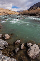 A beautiful landscape of long exposure of water flowing with rocks in the middle and foreground.	