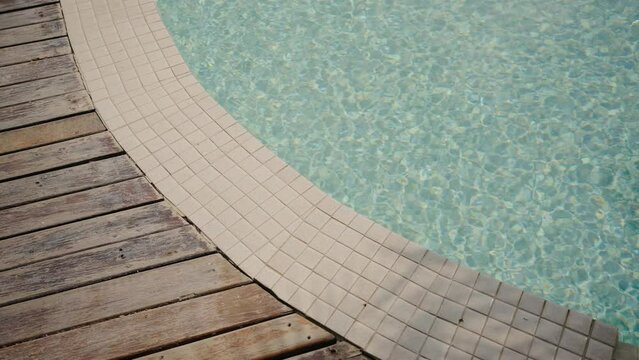 Blue water in the swimming pool with light reflections. swimming pool ripples and wave, Refraction of sunlight top view texture sea side, sun shine water background. Water