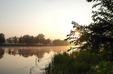 Beautiful early morning, dawn, sunrise over the river, landscape with lake, reflection of trees in the lake