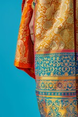 Naklejka premium Vibrant close-up of traditional, intricately woven fabric with colorful patterns and designs on a bright blue background.