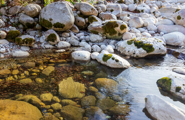 rocky river bottom in shallow water, rock fraction from rock,background for design solutions