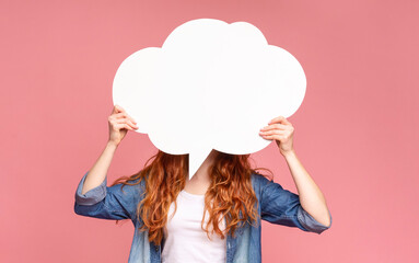 A woman stands with outstretched arms, holding a large white cloud over hear face, expressing her opinion on pink background