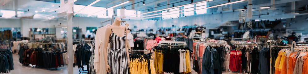 Mannequin Dressed In Female Casual Dress And Clothes On Shelves And Hanger In Store Of Shopping Center