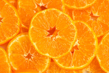 Texture of sweet cut tangerines as background 2