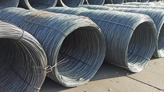 Placing wire rods in coils on a sea pier before loading onto a ship for transportation to the buyer