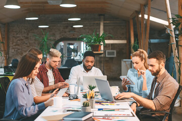 Working process. Young designers working on project, using laptops or digital tablets