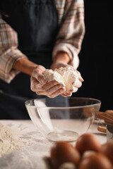 Baker's hands pouring flour into glass bowl, plaid shirt, contrast lighting
