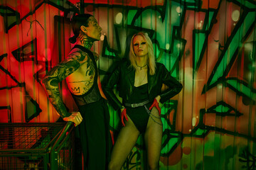 A man and a woman standing next to each other at a lively rave party