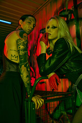 A couple standing side by side at a rave-party or nightclub