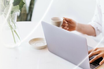 Businesswoman drinking coffee while working at home