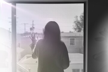 Woman staring out the window during a lockdown remix