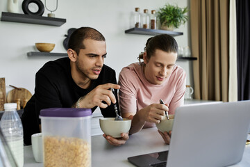 A young gay couple enjoys a casual breakfast together in their modern home.